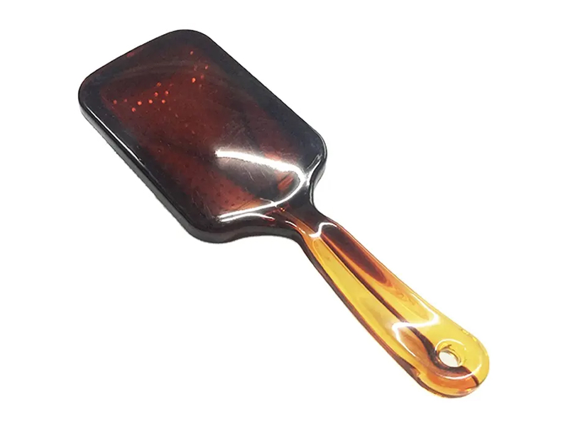 Bärnstensfärgad paddelhårborste med metallnålar